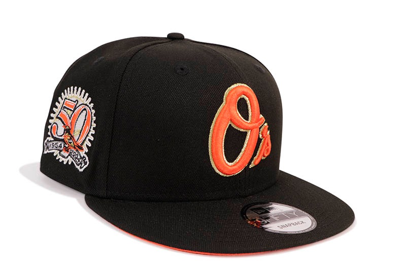 NEW ERA BALTIMORE ORIOLES 9FIFTY SNAPBACK CAP (50TH ANNIVERSARY SIDE PATCH/ORANGE UNDER VISOR/BLACK)