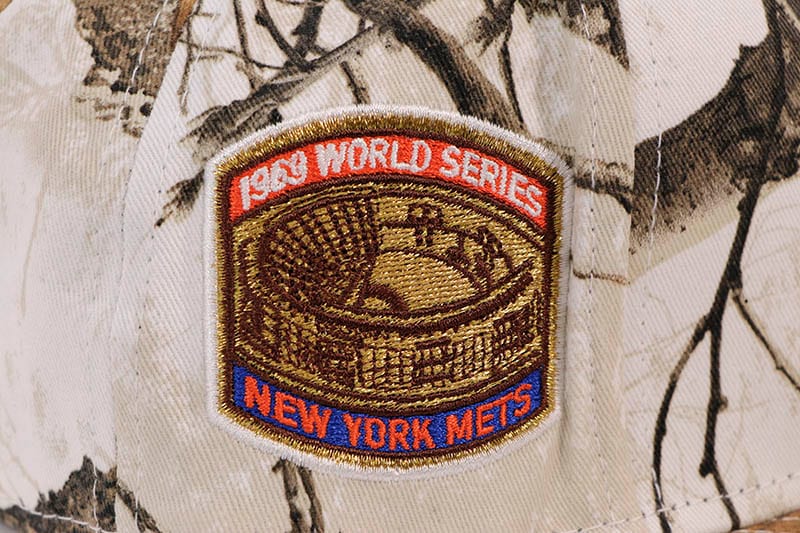 NEW ERA NEW YORK METS 59FIFTY FITTED CAP (1969 WORLD SERIES SIDE PATCH/ORANGE UNDER VISOR/REALTREE SNOW CAMO)