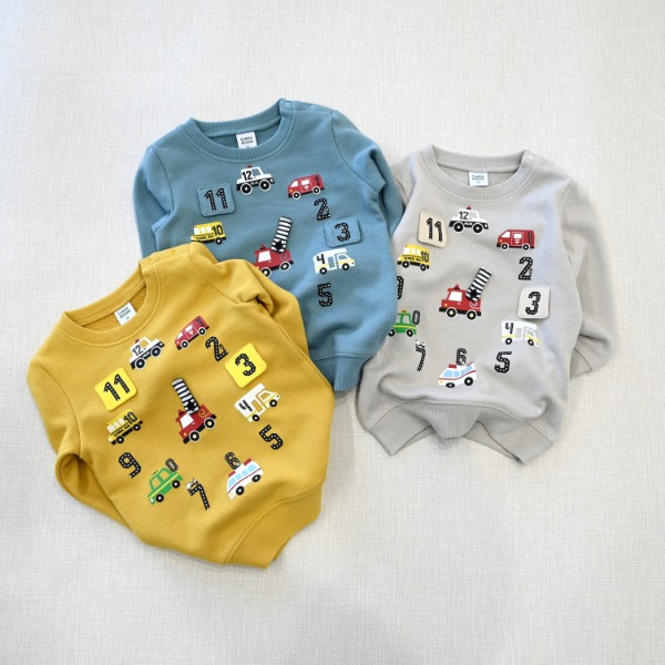 【25FW】働く車の時計 トレーナー / マスタード