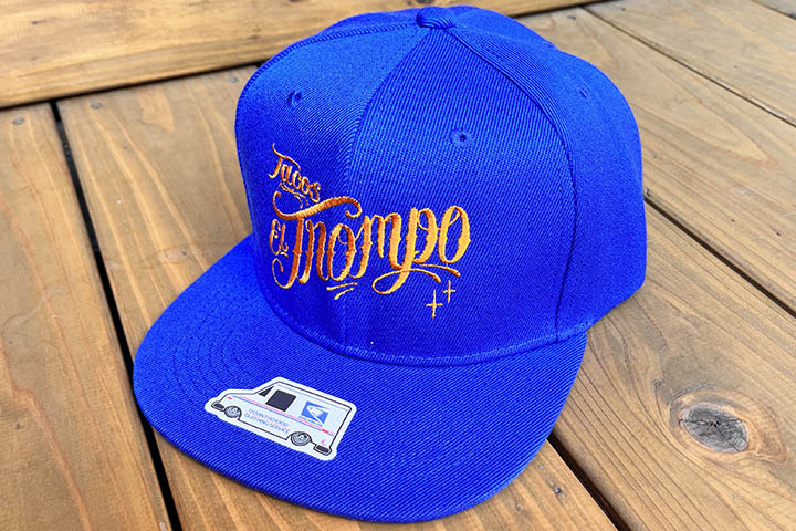 Tacos El Trompo snapback cap (script) / royal x orange