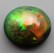 エチオピアオパール ルース 4.17ct 淡橙の地色に橙 緑 赤の遊色