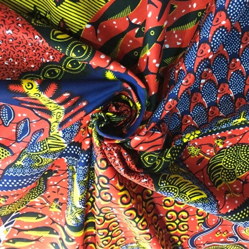 ＜sale＞アフリカンプリント生地 0.5m(50cm)単位 AP-13022　神の目 子安貝 魚 オレンジ濃紺