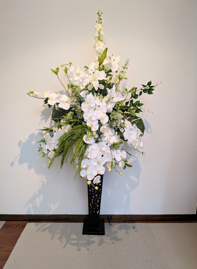 高品質デザイン: 本物のような美しい胡蝶蘭のアレンジメントで、触媒加工により長期間美しさを保ちます イベント用途: 結婚式場やイベント会場、店舗ディスプレイなど、様々な場面で活躍する豪華なスタンドフラワーです メンテナンス不要: 水やりや日光の心配が不要で、いつでも美しい状態を保つことができます ゴージャス演出: 華やかな胡蝶蘭の花々が空間を上品に演出し、特別な雰囲気を作り出します お祝い装飾: 開店祝いや周年記念、式典など、様々なお祝いの場面に相応しい豪華な装飾アイテムです